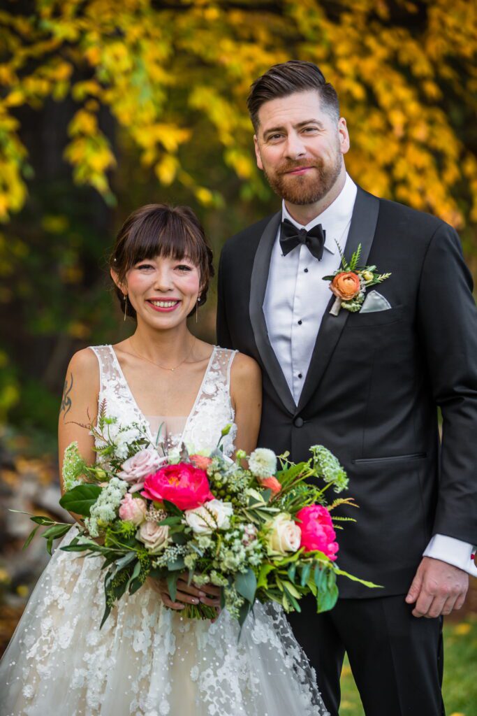 Kaori and Brian with a colorful wedding bouquet in Manchester, New Hampshire