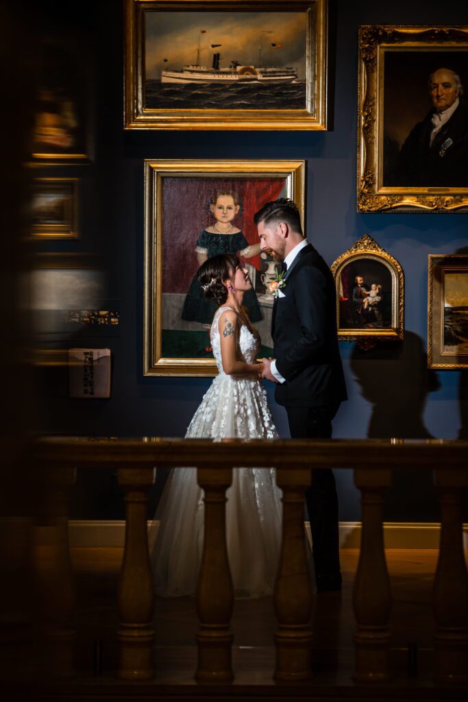 Kaori and Brian surrounded by paintings inside the Currier Museum of Art