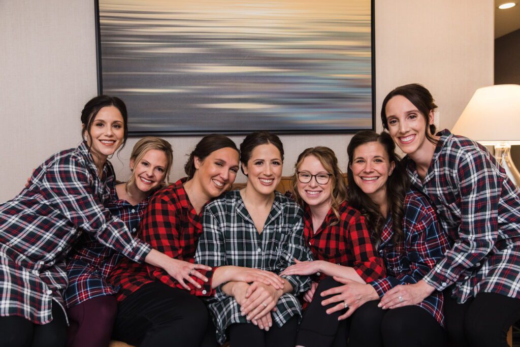 Nicole and her bridesmaids wearing plaid pajamas while getting ready