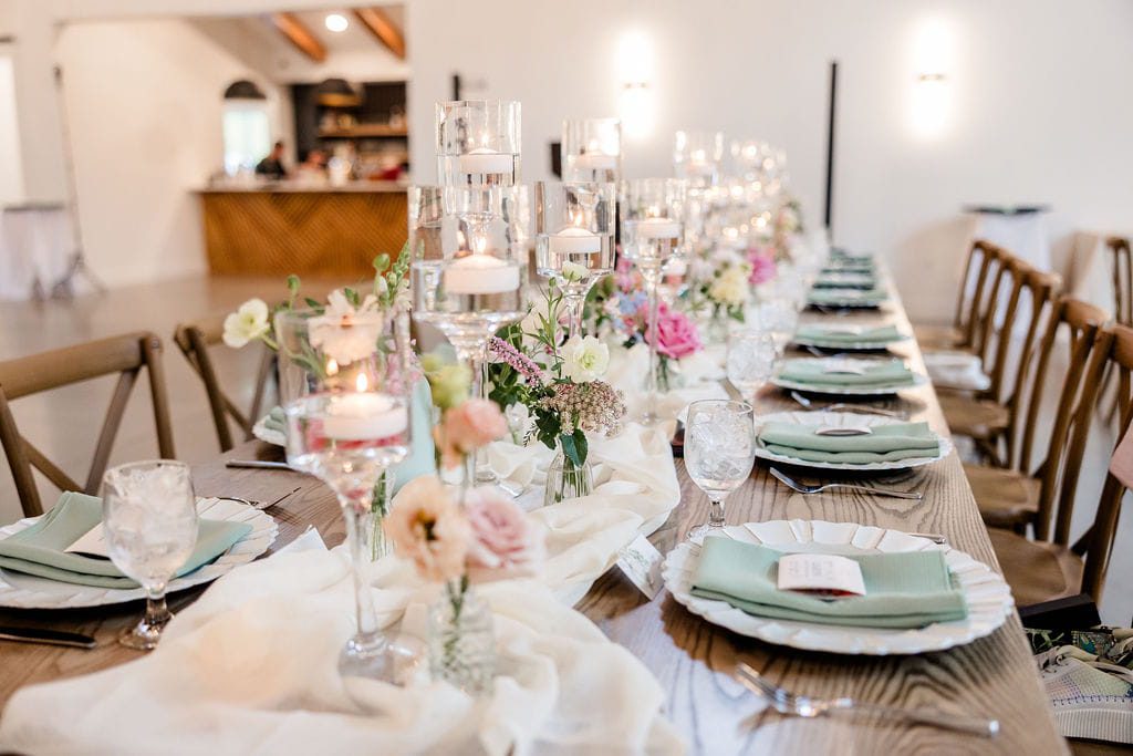 Tablescape with floating candles and beautiful wildflowers for summer wedding at Hyla Brook Estate
