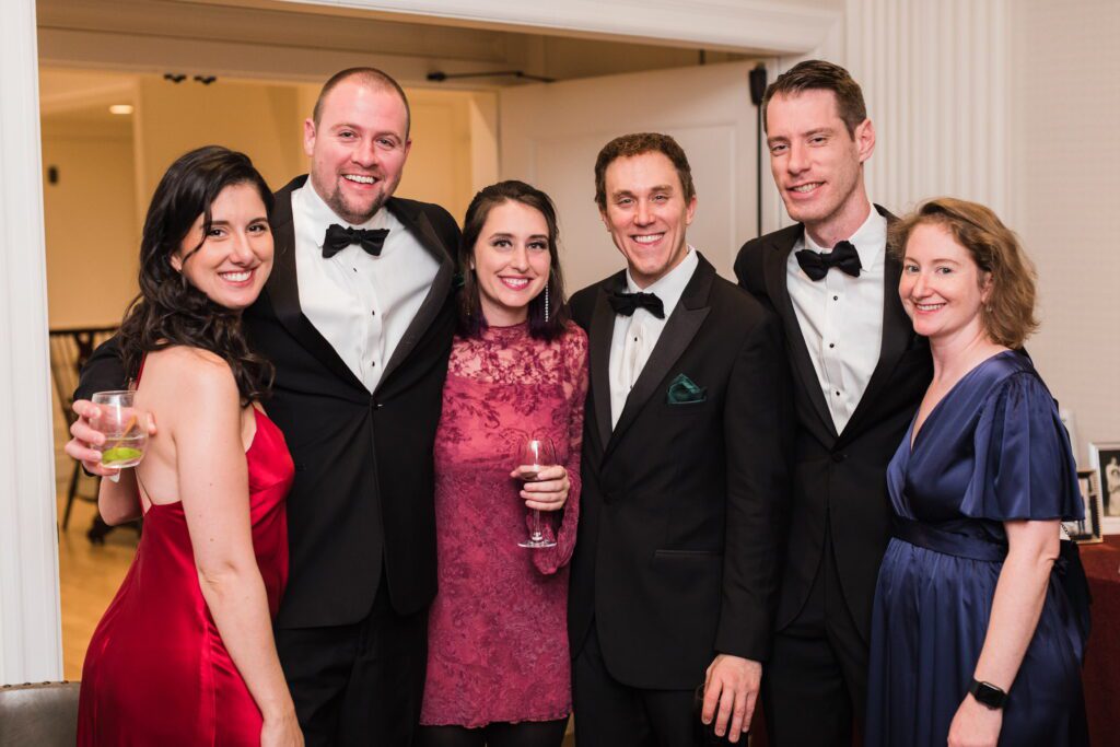 Guests in tuxedos and formal dresses at a black-tie New England wedding