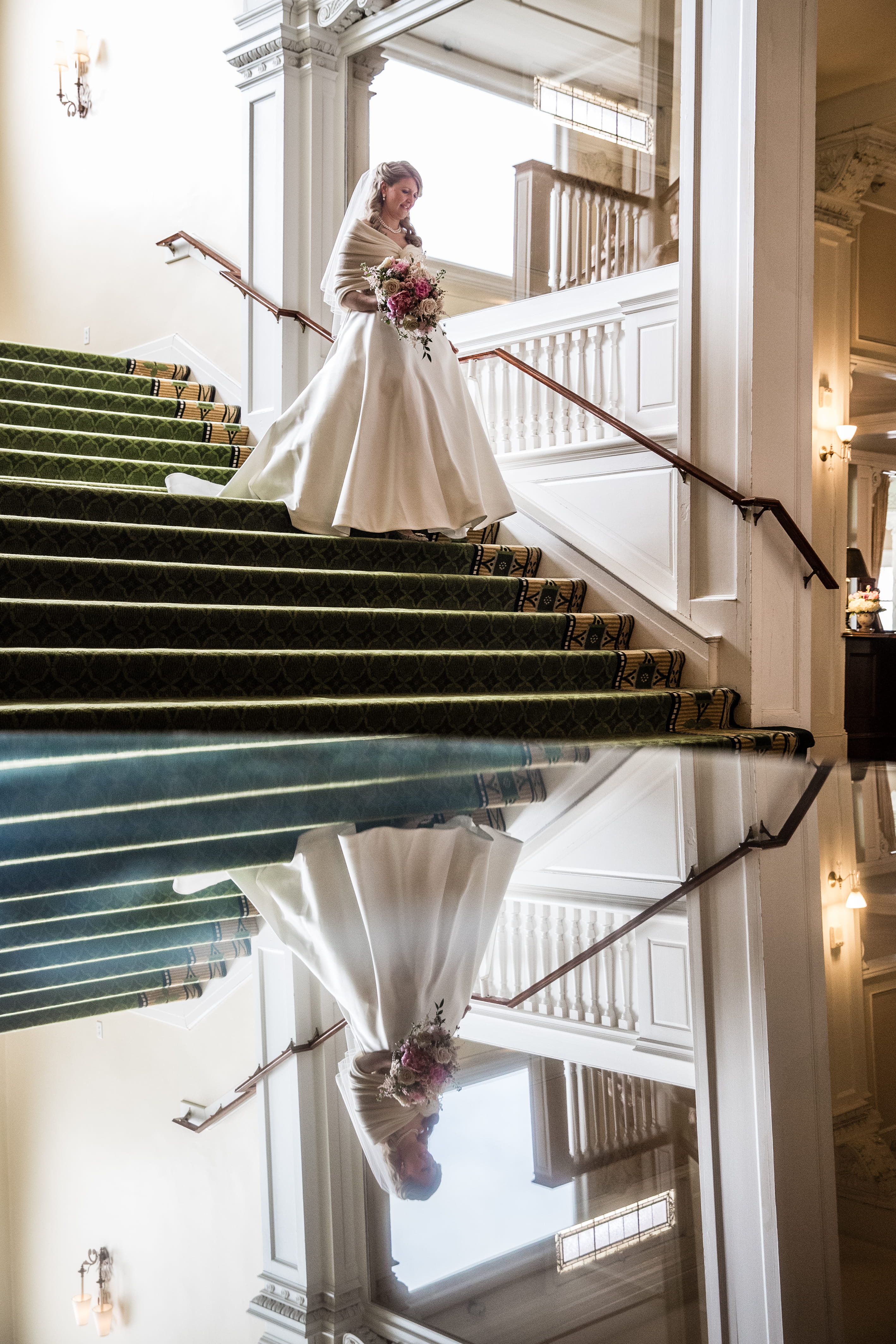 Francesca descending the staircase inside the Omni Mount Washington Resort