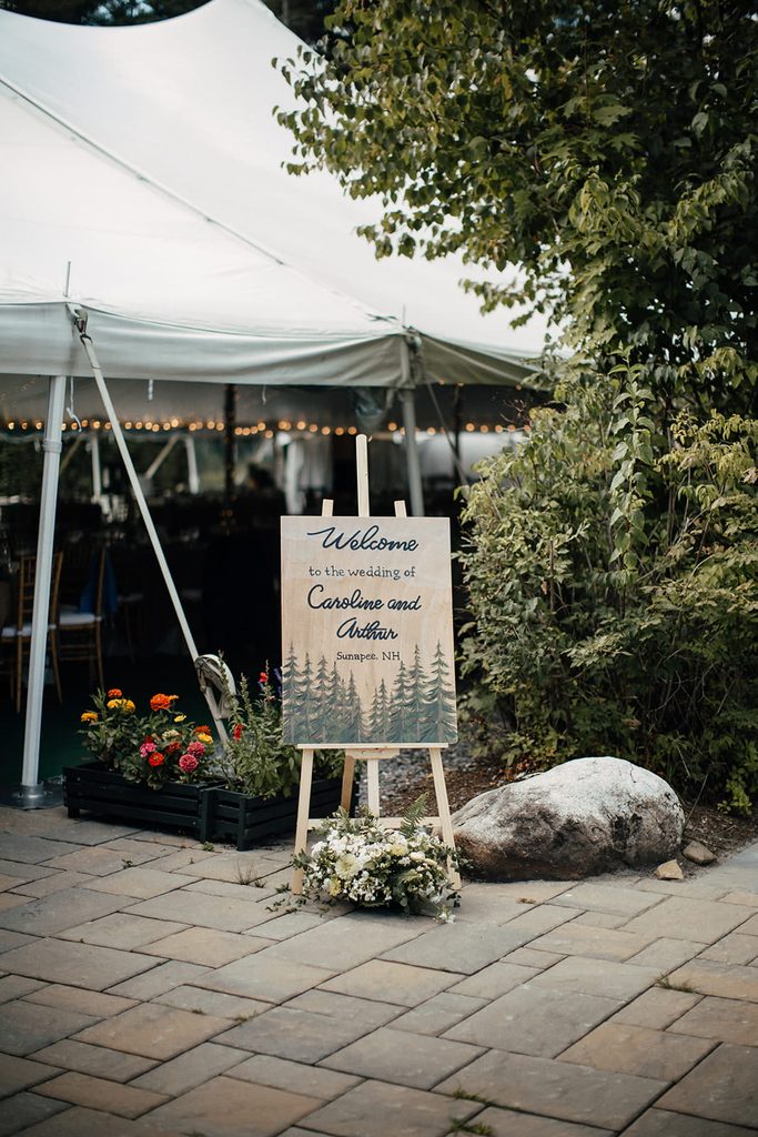 Woodsy wedding welcome sign outside the reception tent at Dexter’s Inn