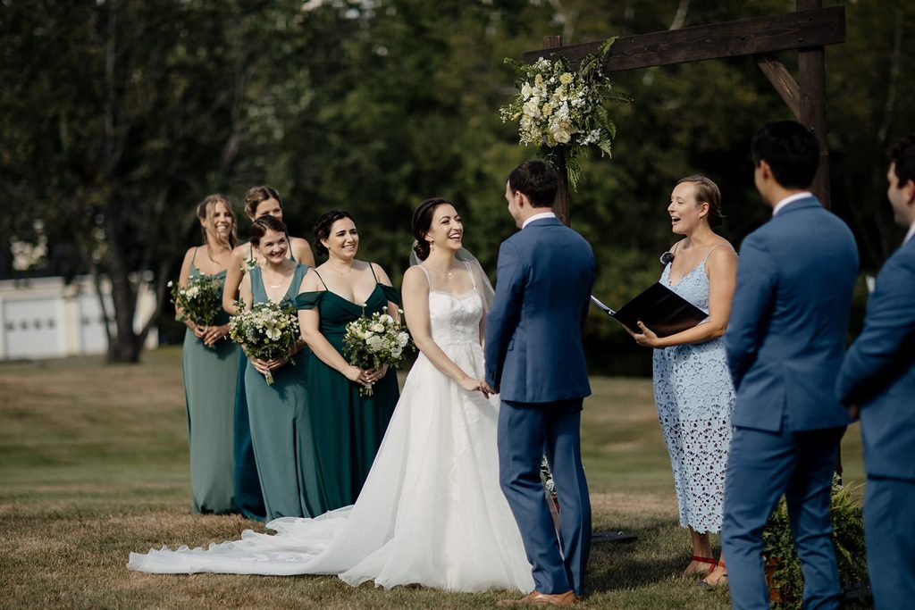 Caroline and Arthur laughing during their outdoor ceremony at Dexter’s Inn