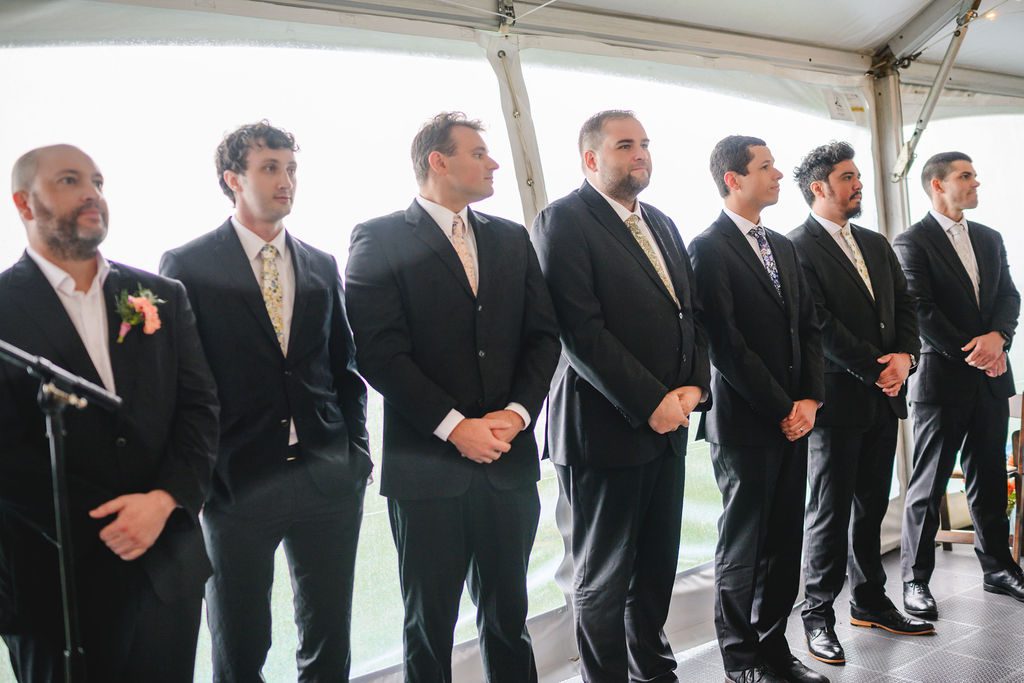 Wedding party wearing coordinated dark suits and different floral ties at the Seacoast Science Center in Rye, New Hampshire