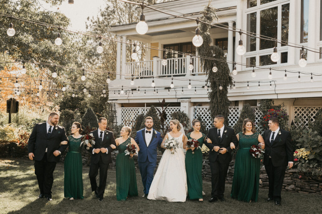 Wedding party in coordinated blue, black, and emerald attire at Bedford Village Inn in Bedford, New Hampshire