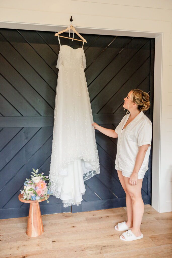 Emily admiring her wedding dress at Hyla Brook Estate