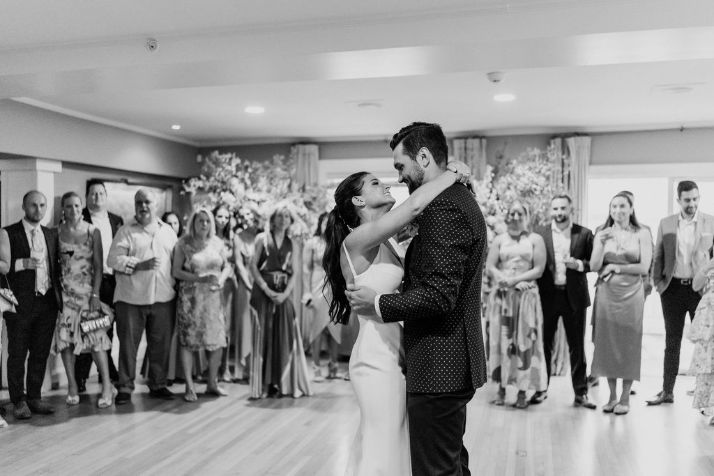 Erin and Rob smiling during their first dance at the Boston Yacht Club