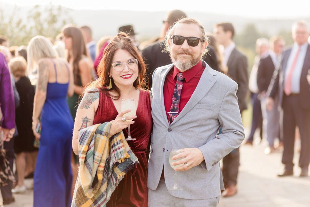 Couple in fall wedding attire with a plaid wrap for cool weather