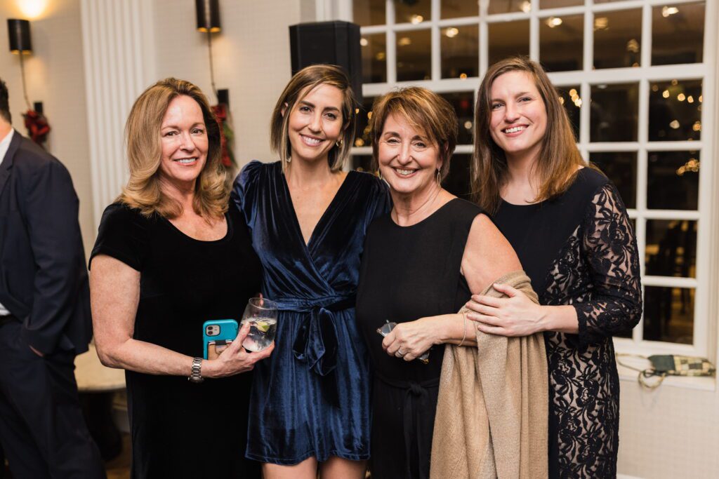 Women wearing velvet and lace dresses at a formal winter wedding