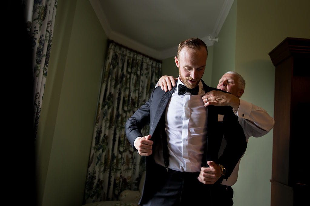 Alex receiving help with his tuxedo at the Omni Mount Washington