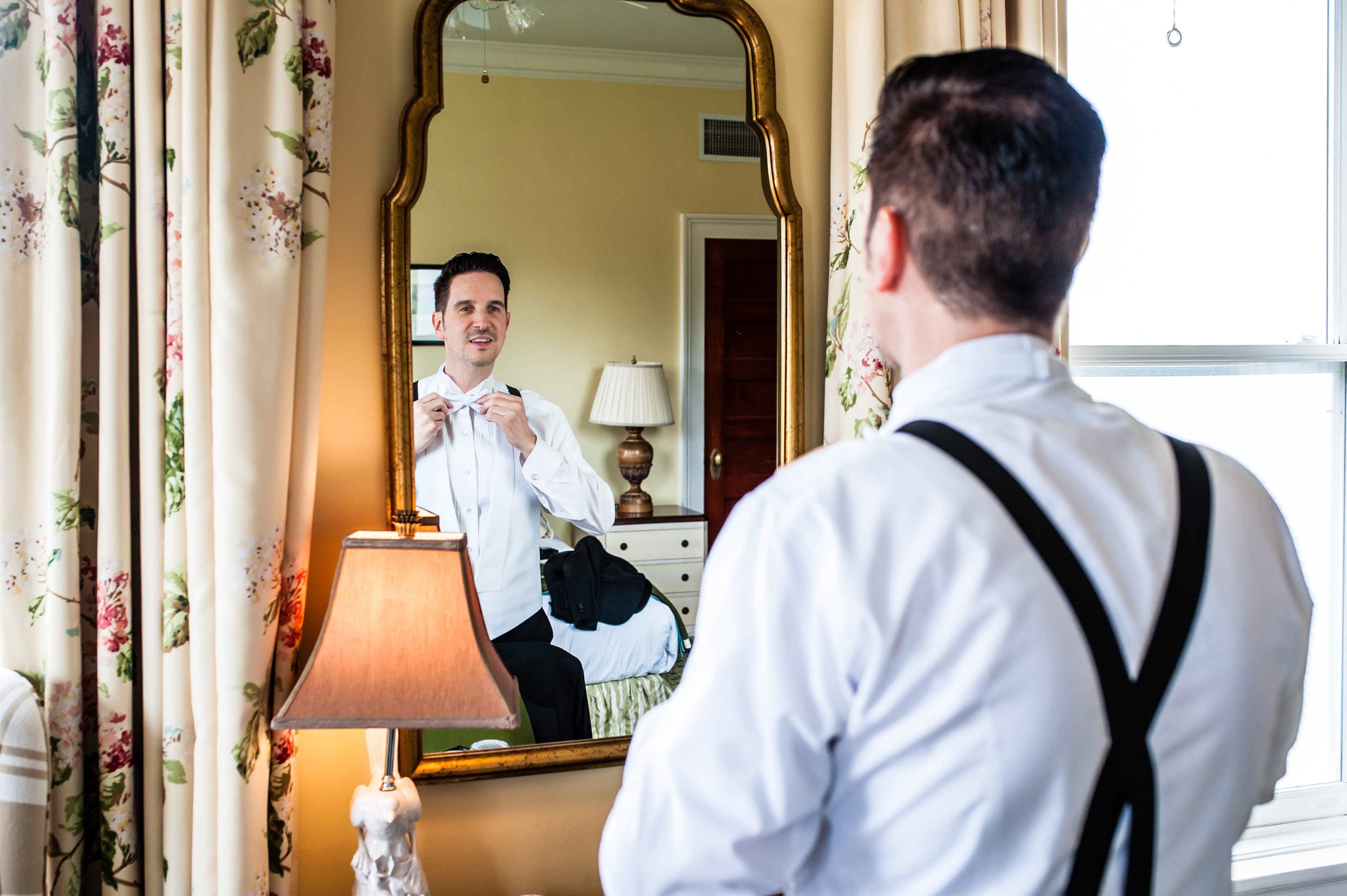Bernard adjusting his white bow tie before his Omni Mount Washington wedding