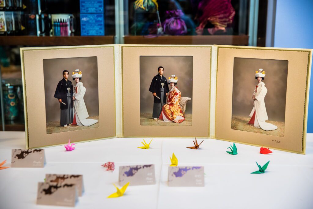 Japanese wedding photographs displayed with colorful origami cranes