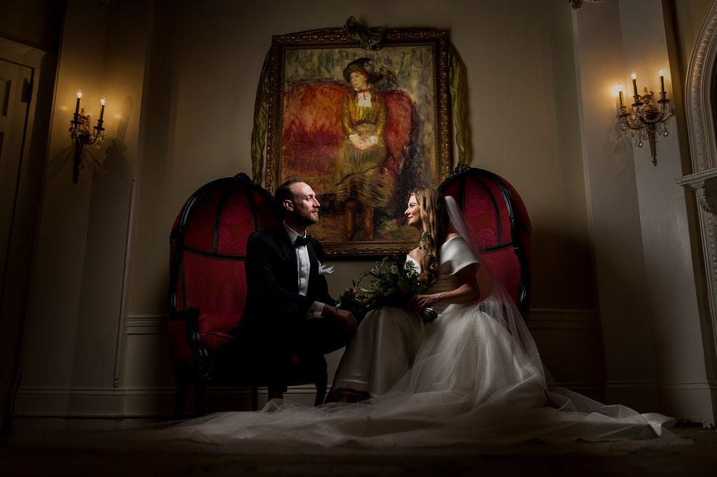 Katie and Alex seated together inside the historic Omni Mount Washington Resort