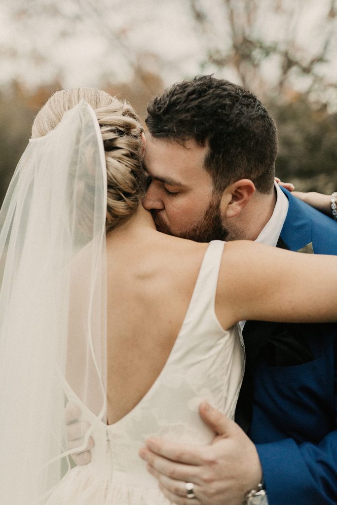 Kerry and Jake embracing during their fall wedding in New Hampshire