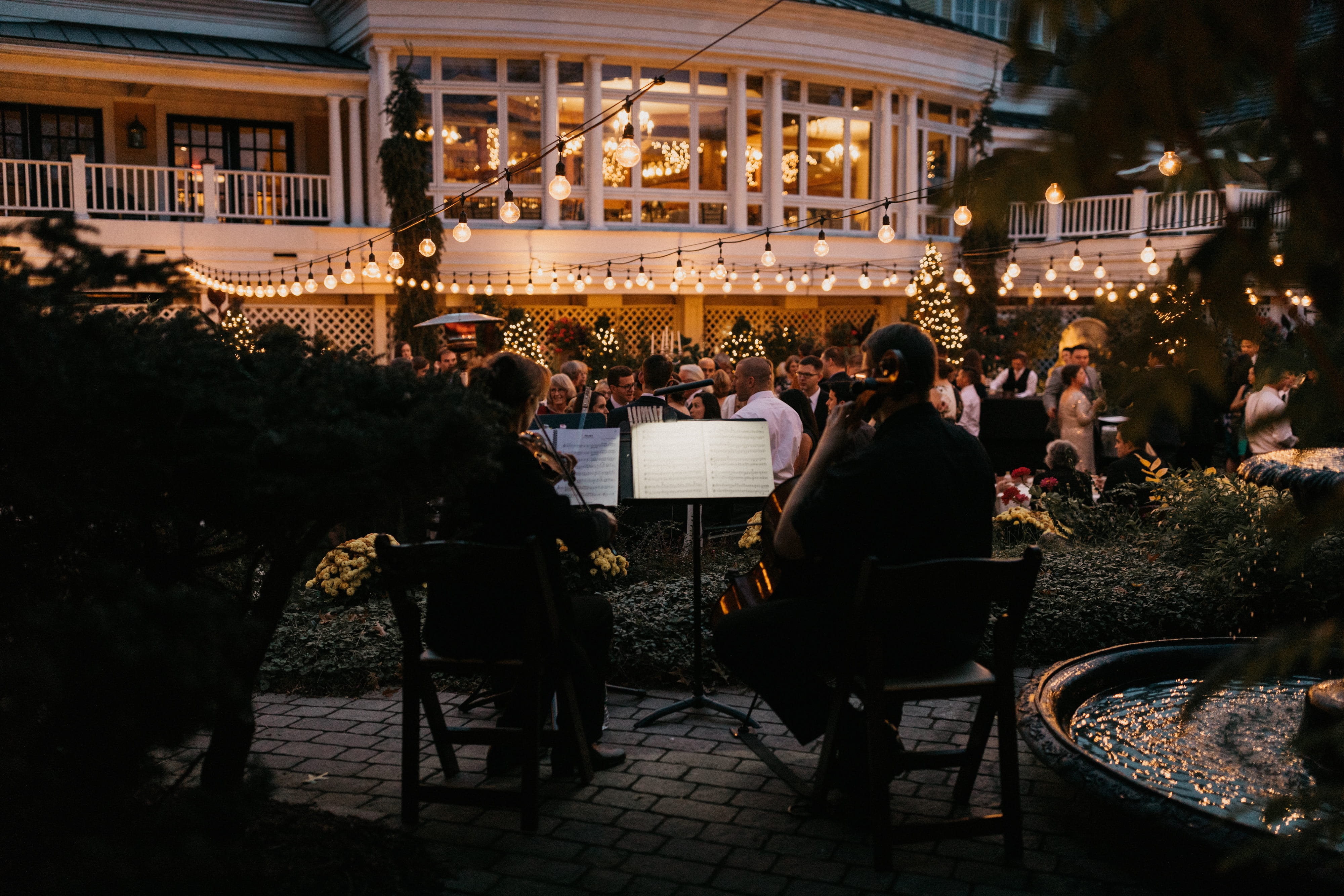 Live string musicians performing during cocktail hour at Bedford Village Inn