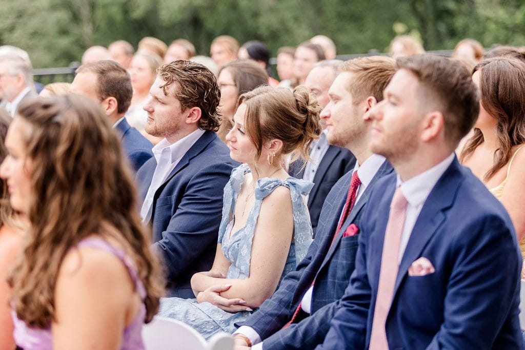 Men wearing summer suits while attending an outdoor New England wedding
