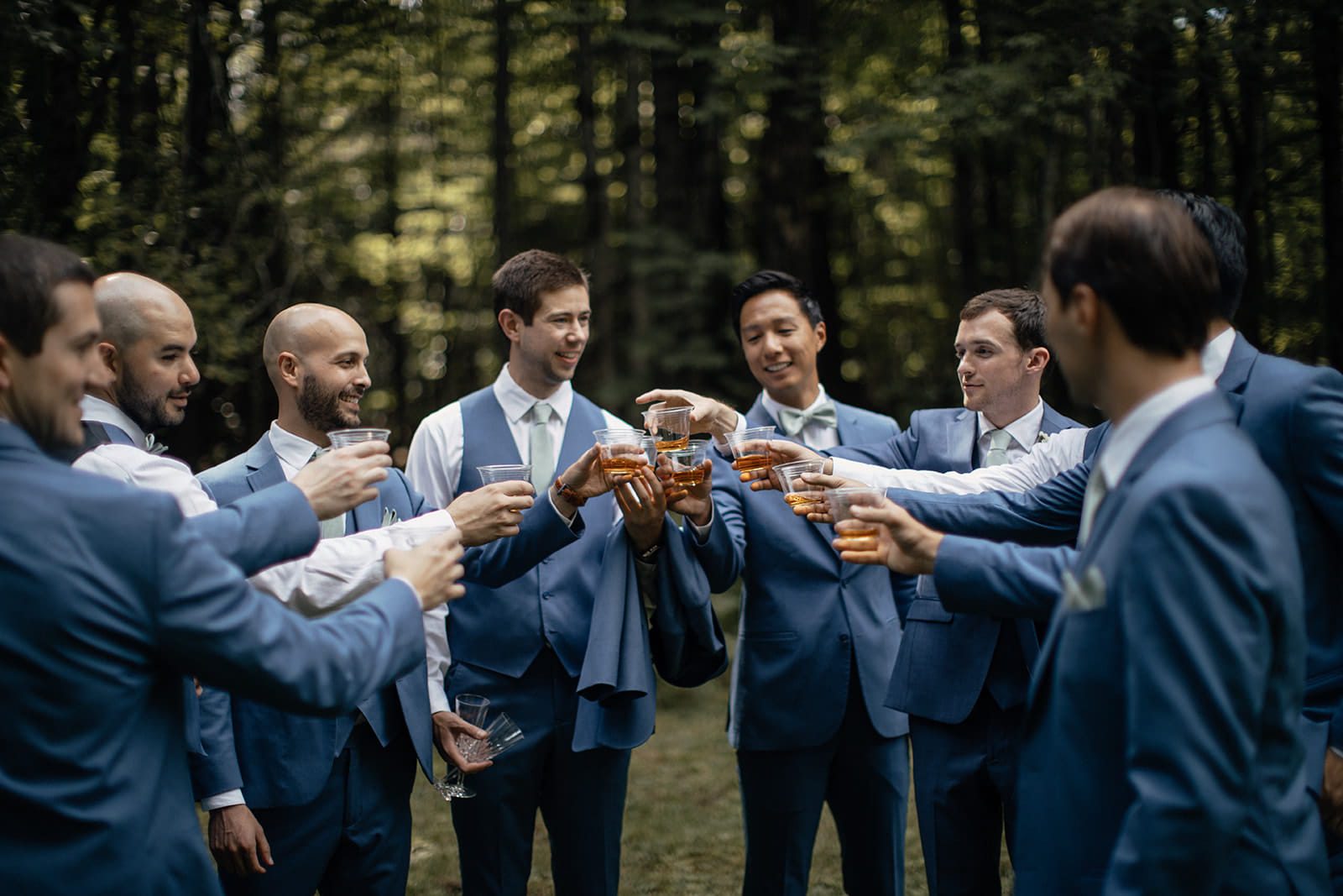 Arthur and his groomsmen sharing a toast in navy suits