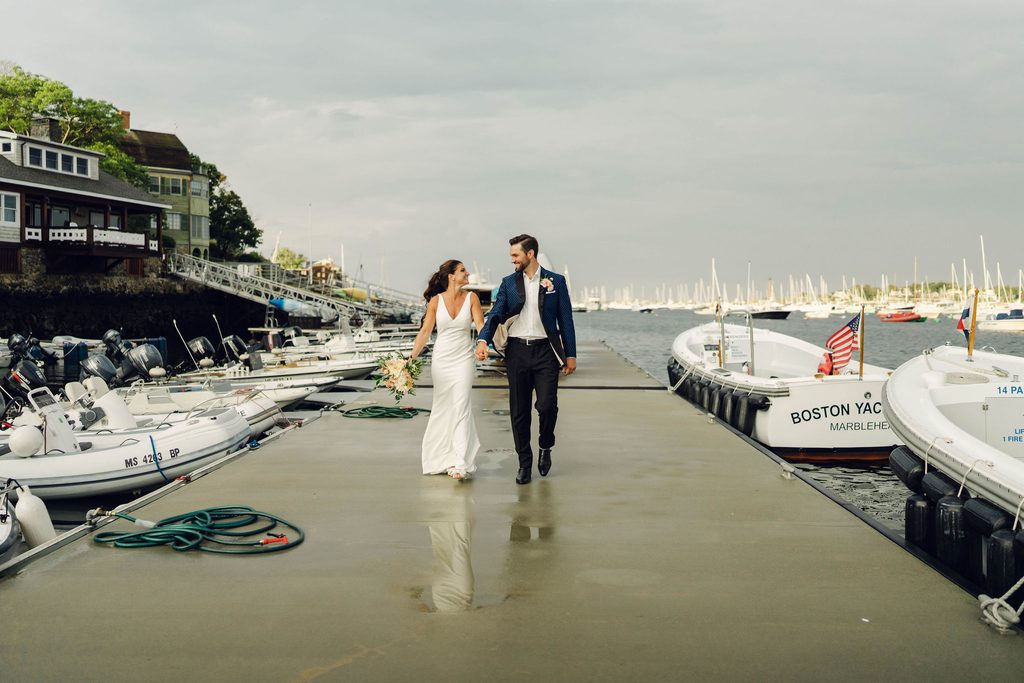 Erin and Rob walking along the Boston Yacht Club dock after the rain