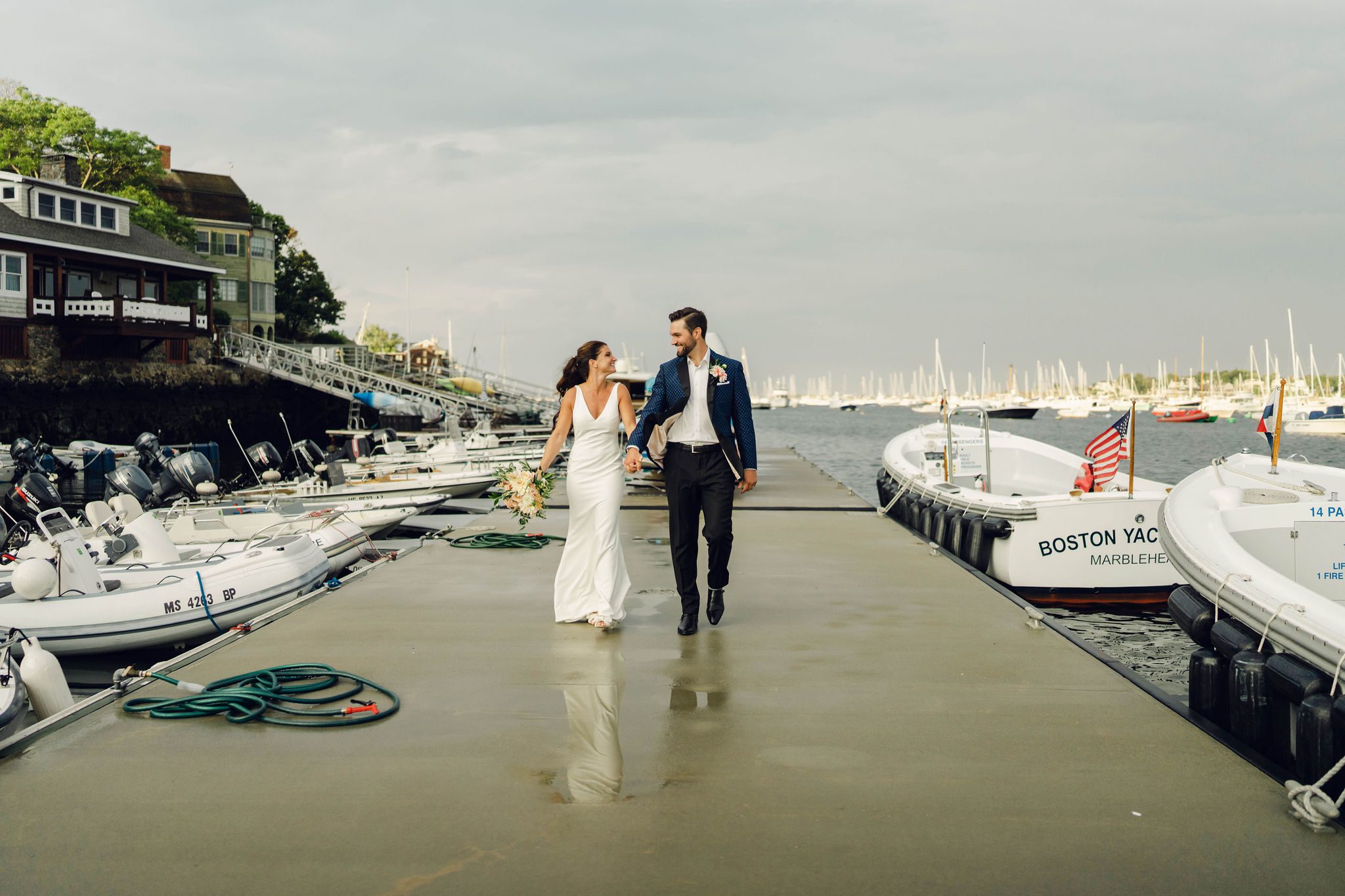 Erin and Rob walking along the Boston Yacht Club dock after the rain