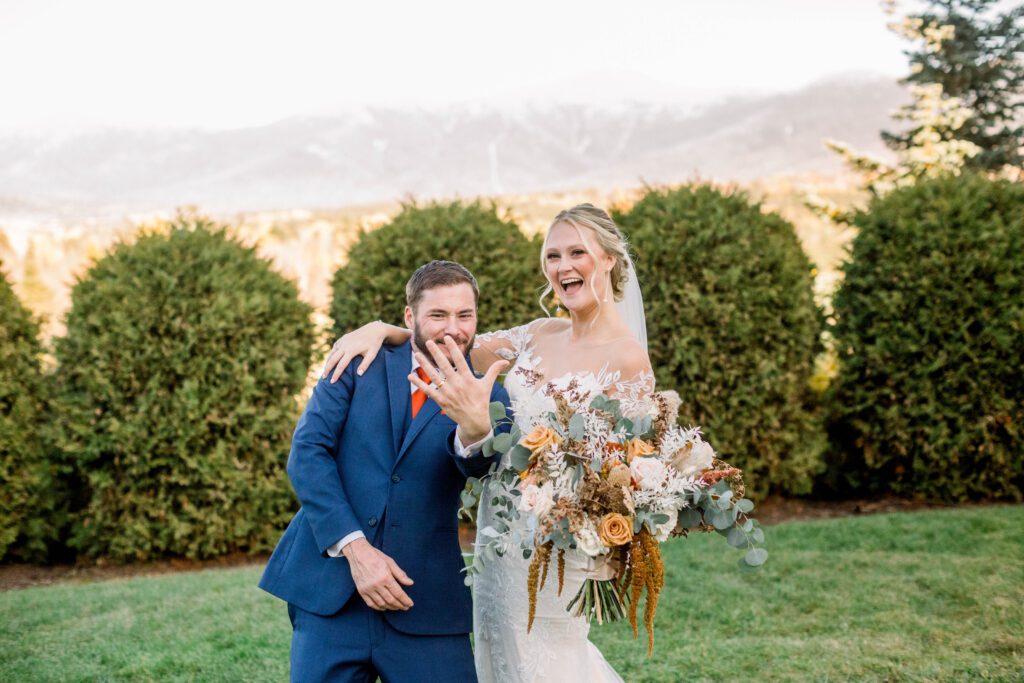 Nicole and Tom celebrating as newlyweds with the White Mountains behind them