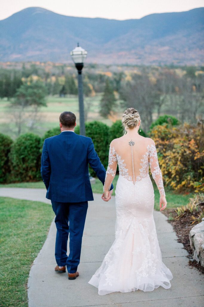 Nicole and Tom walking hand in hand after their Mount Washington wedding