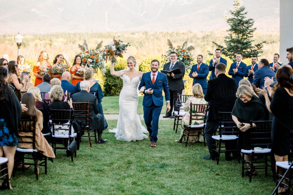 Nicole and Tom celebrating as they walk back down the aisle after their ceremony
