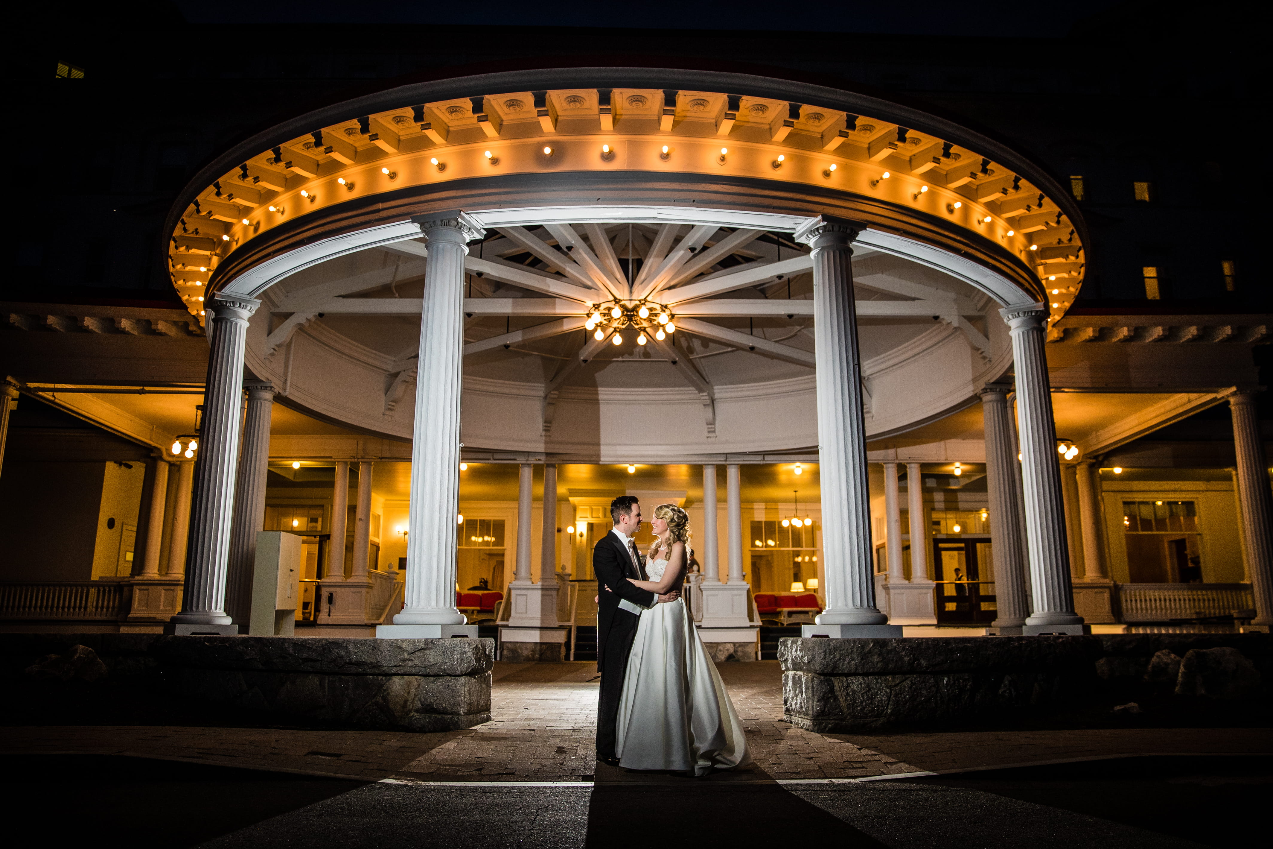 Francesca and Bernard beneath the illuminated entrance of the Omni Mount Washington