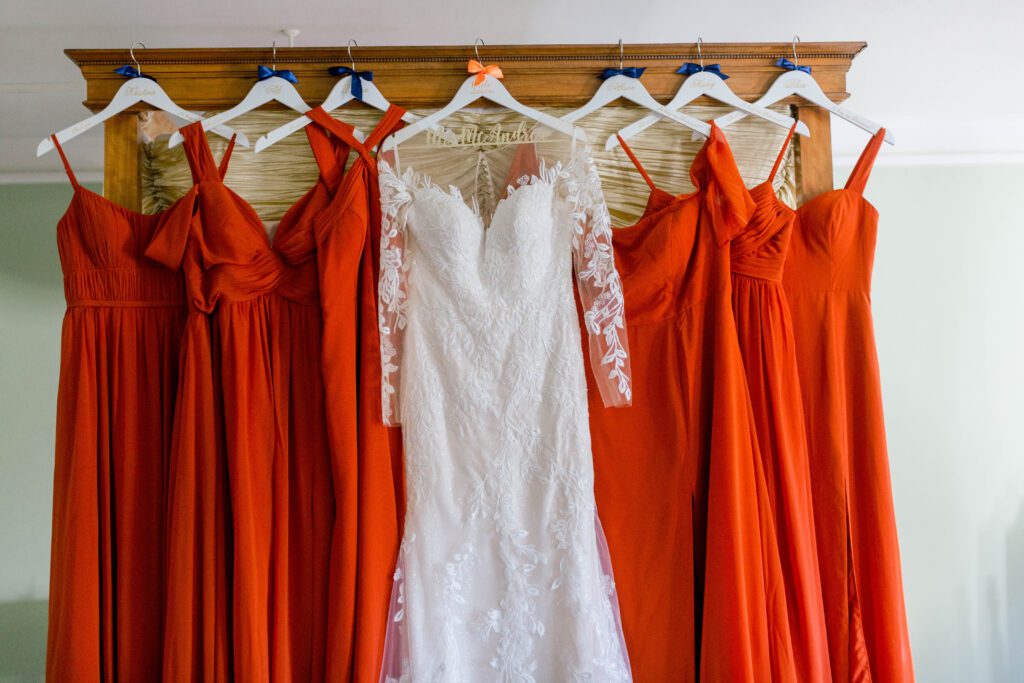Nicole’s lace wedding gown displayed with burnt orange bridesmaid dresses