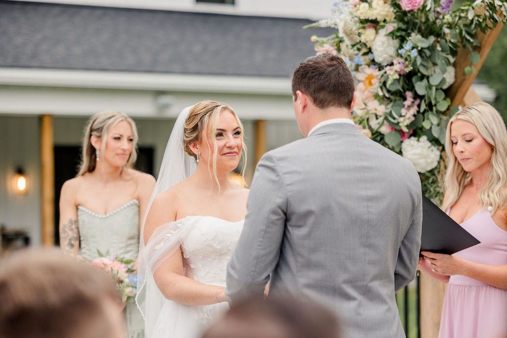 Emily and Cory exchanging vows at their outdoor Hyla Brook Estate ceremony