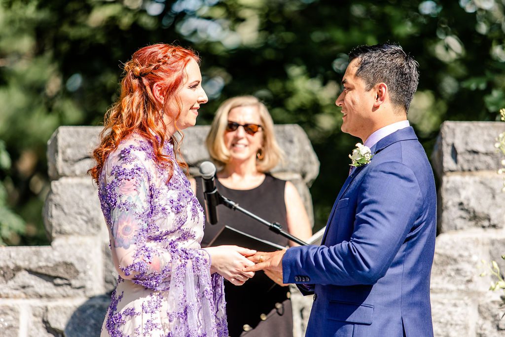 Bride in a purple wedding dress exchanging vows at Searles Castle in Windham, New Hampshire