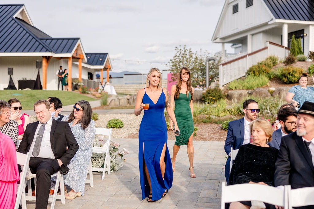 Guests arriving in formal dresses for an outdoor New England ceremony