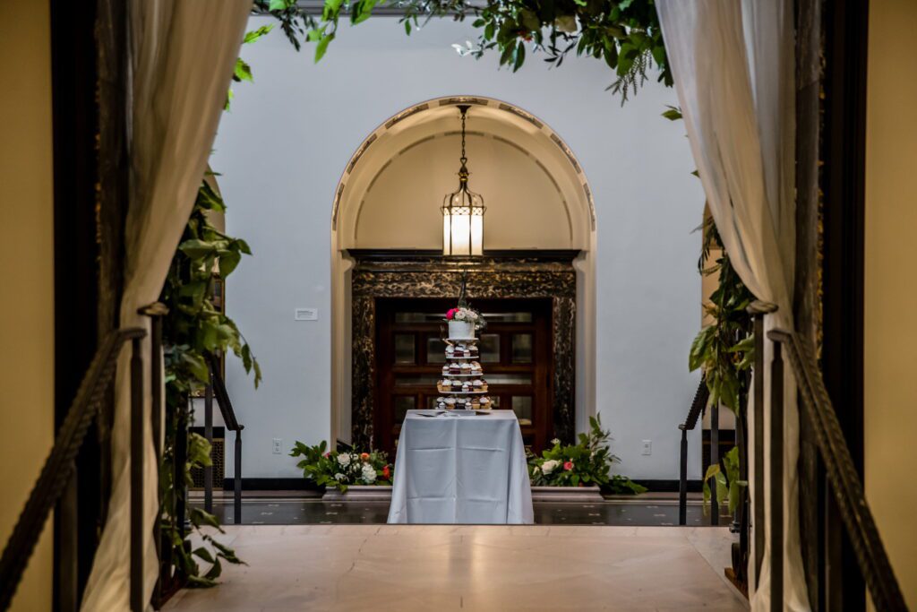Wedding cupcake display framed by greenery inside the Currier Museum